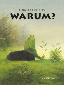 © minedition AG Ein Frosch sitzt auf einem Stein auf einer Wiese.