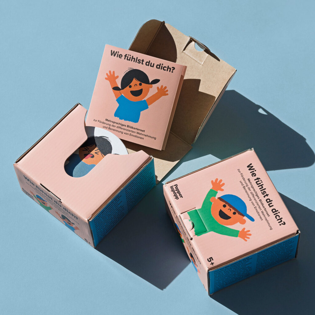 Kartenset und Verpackung mit Karten, auf denen junge Menschen verschiedene Emotionen zeigen.